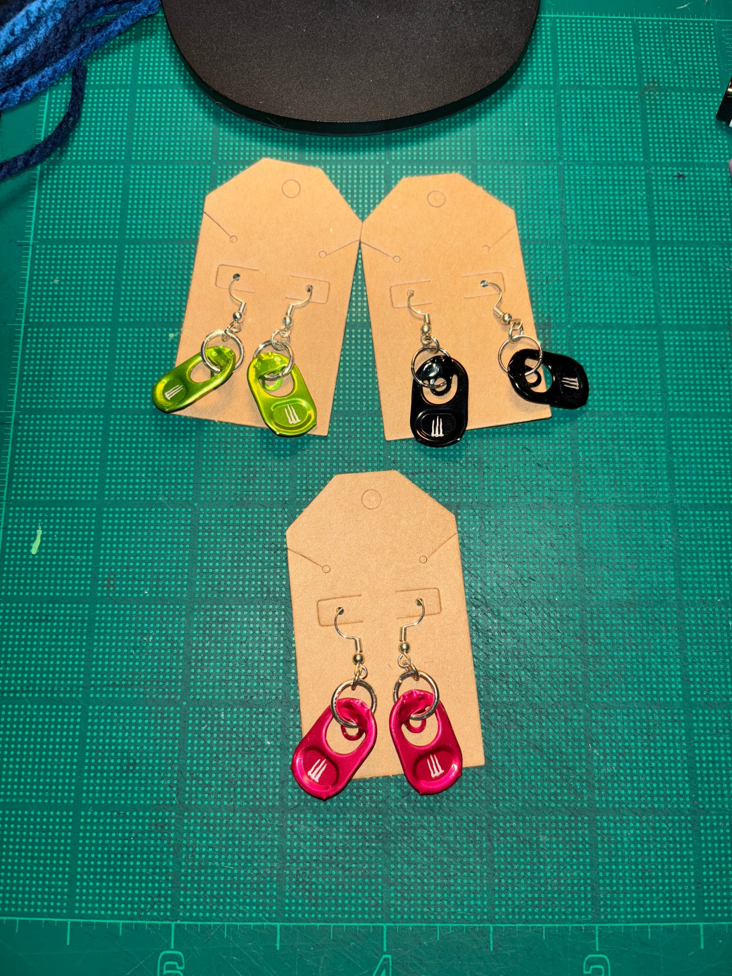 Monster tab dangling earrings